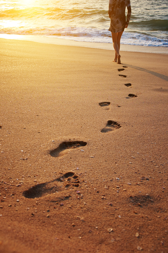 Footprints on the beach sand.Traces on the beach. Footsteps on the beach by the sea in summer