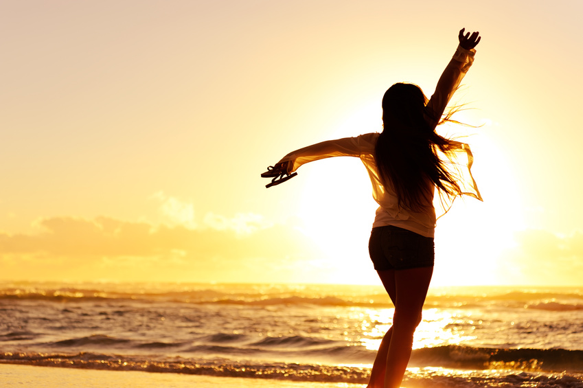 Silhouette of a happy woman dancing